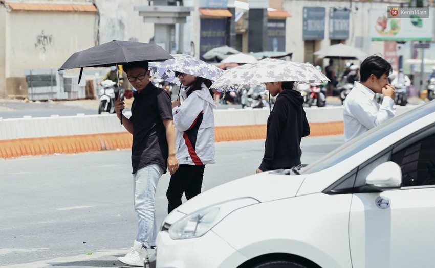 Người Sài Gòn nằm la liệt dưới bóng cây trên phố Nguyễn Huệ để trốn cái nóng hầm hập gần 40 độ C - Ảnh 2.