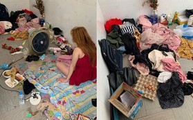 Hình ảnh cô gái mặc váy 2 dây ngồi nghịch điện thoại giữa căn phòng bừa bộn, ngập rác khiến nhiều người choáng váng