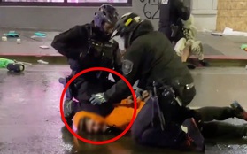 Cảnh sát Mỹ ghì cổ để khống chế người 'hôi của' trong cuộc biểu tình nhưng được đồng nghiệp ngăn cản kịp thời