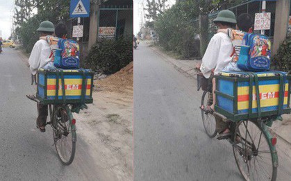 Bố đèo con nhỏ trên xe đạp, chữ viết phía sau thùng hàng khiến nhiều người nghẹn ngào