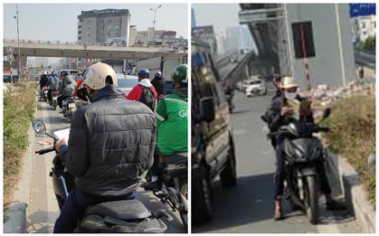 Đang dừng đèn đỏ nhưng chợt nhớ tới phải ôn bài, nam sinh mang sách vở ra học ngay giữa trời nắng
