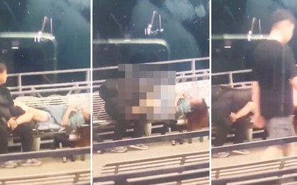 Cặp đôi "thân mật" trên ghế bị người đi đường dùng điện thoại ghi hình và thông báo từ chính quyền