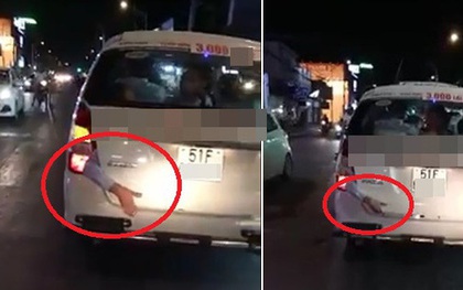 Hình ảnh rùng rợn: Cánh tay bị kẹp ở cốp xe taxi chạy trên phố Sài Gòn