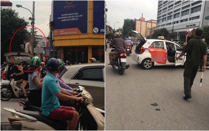 Hà Nội: Đi vào đường cấm bị CSGT nhắc nhở, tài xế taxi leo lên nóc ô tô "ăn vạ"