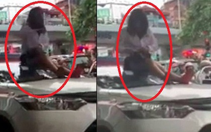 Bị CSGT dừng xe vì vượt đèn đỏ, nữ tài xế taxi trèo lên nóc xe ăn vạ