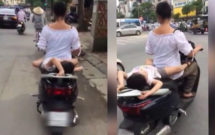 Clip: Người phụ nữ đèo em bé nằm ngửa ra yên xe khiến người đi đường hoảng sợ