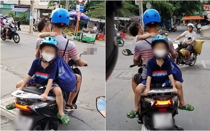 Một tay bế con một tay lái xe máy, phía sau còn cho con trai ngồi đối lưng vắt vẻo, ông bố trẻ nhận vô số chỉ trích
