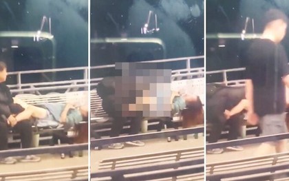 Cặp đôi "thân mật" trên ghế bị người đi đường dùng điện thoại ghi hình và thông báo từ chính quyền