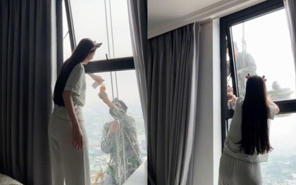 Mát lòng cảnh cô gái mời nước anh thợ treo mình giữa trời nóng lau kính cao ốc