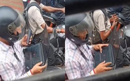 Bức ảnh gây bão mạng toàn thế giới: Mở laptop làm việc khi xe máy chờ đèn đỏ