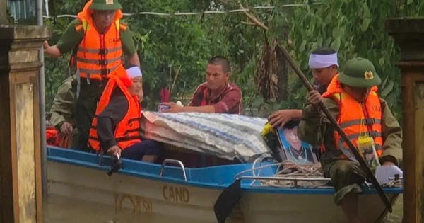 Công an dùng xuồng máy vượt lũ đưa thi thể cụ bà đi an táng
